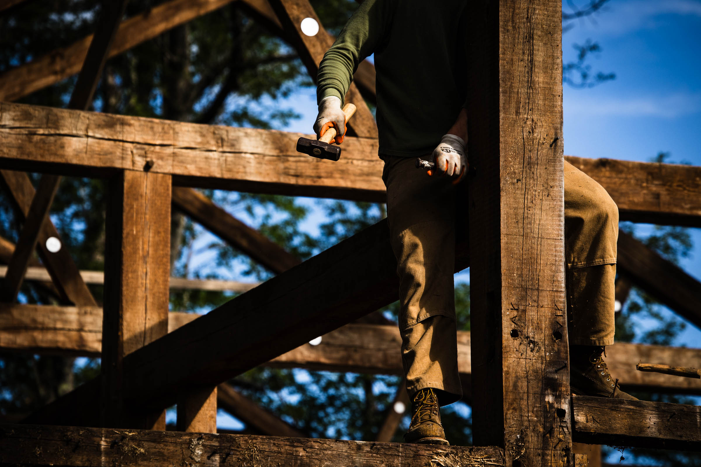 Timber framer working on a vintage barn in Maine